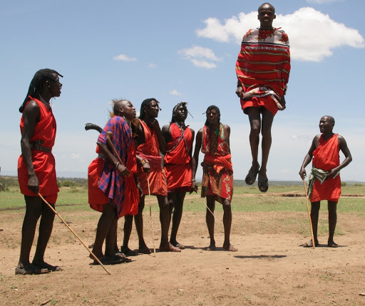 Maasai warriors performing traditional dance during cultural visit on 3 days Masai Mara safari