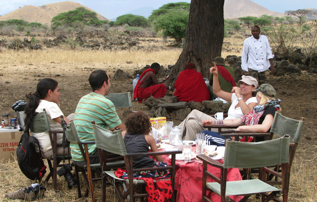Safari group enjoying a bush breakfast on a 3-Day Masai Mara Safari from Nairobi with Armani Tours and Travel