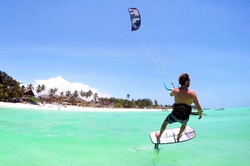 Paje Beach Zanzibar — endless white sand coastline with kitesurfers, one of the best beaches in Zanzibar on the east coast