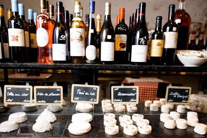 France Tours 5 Wine tasting in Bordeaux château cellar with oak barrels and sommelier, essential France wine tours experience