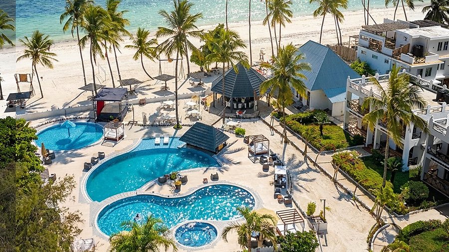 Pristine Zanzibar Beachfront — Crystal turquoise waters meeting powder-white sand at a luxury all inclusive resort